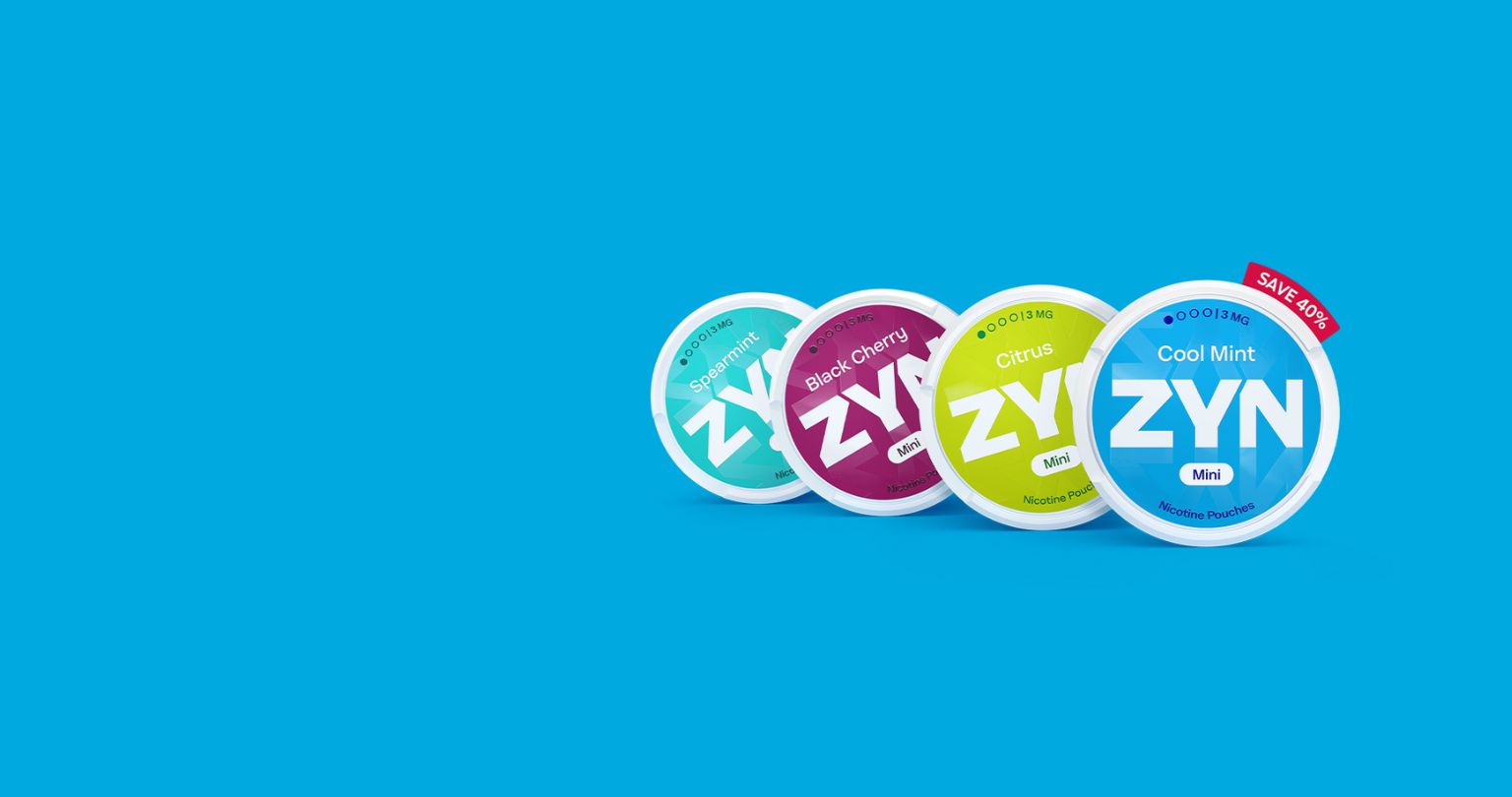 A man working on a laptop while holding an IQOS ILUMA device.